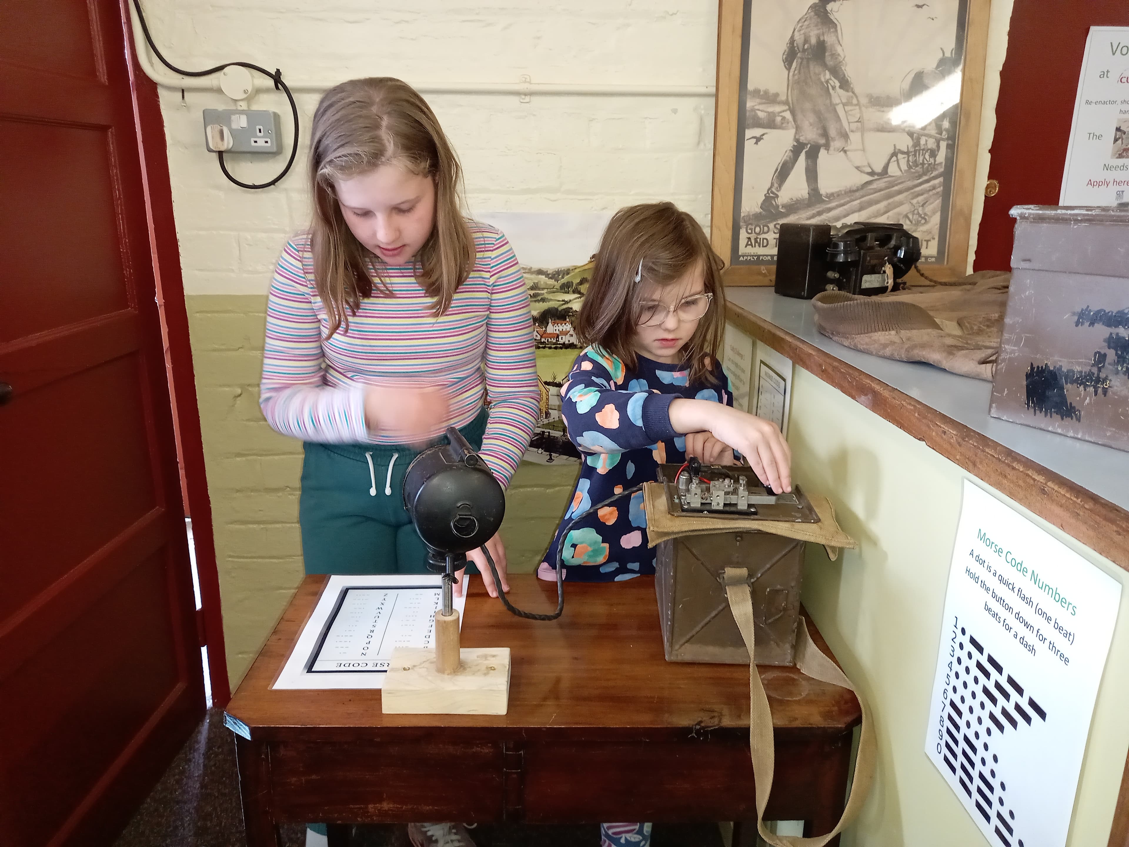 Children using a hands-on Morse code exhibit at Comrie Museum